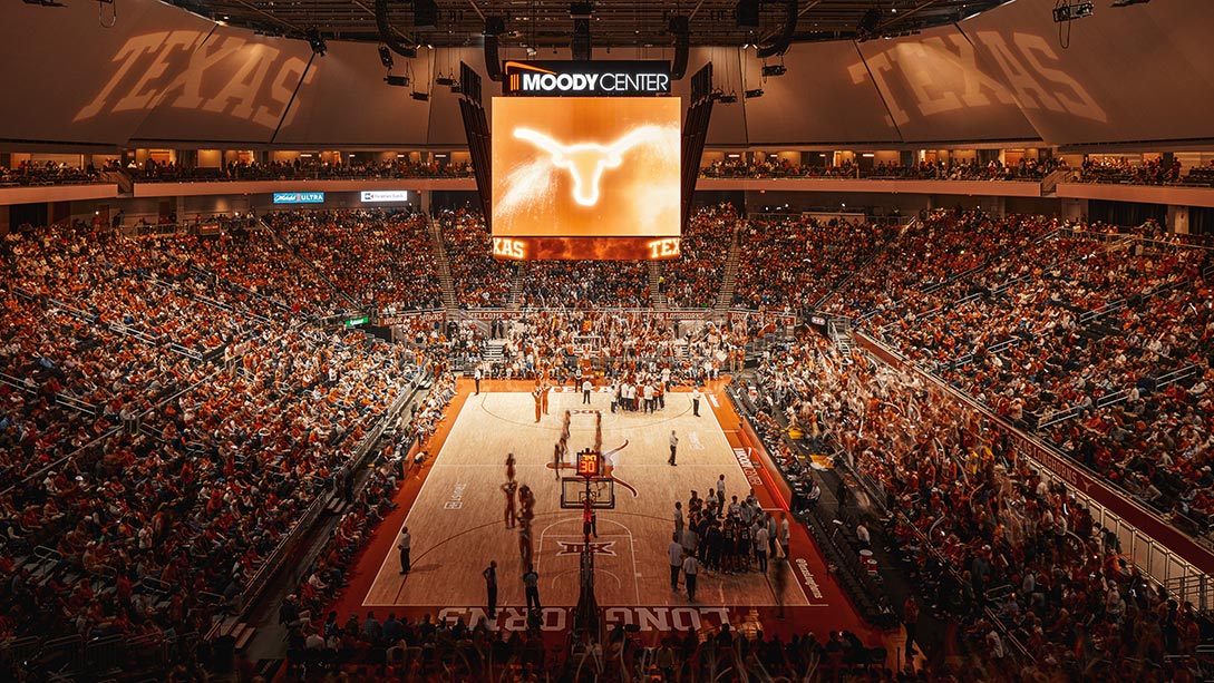 A basketball court with a crowd watching.