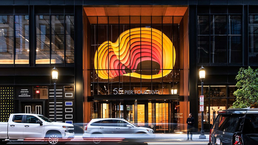 Street entrance to 111 Harbor Way featuring large lighted installation