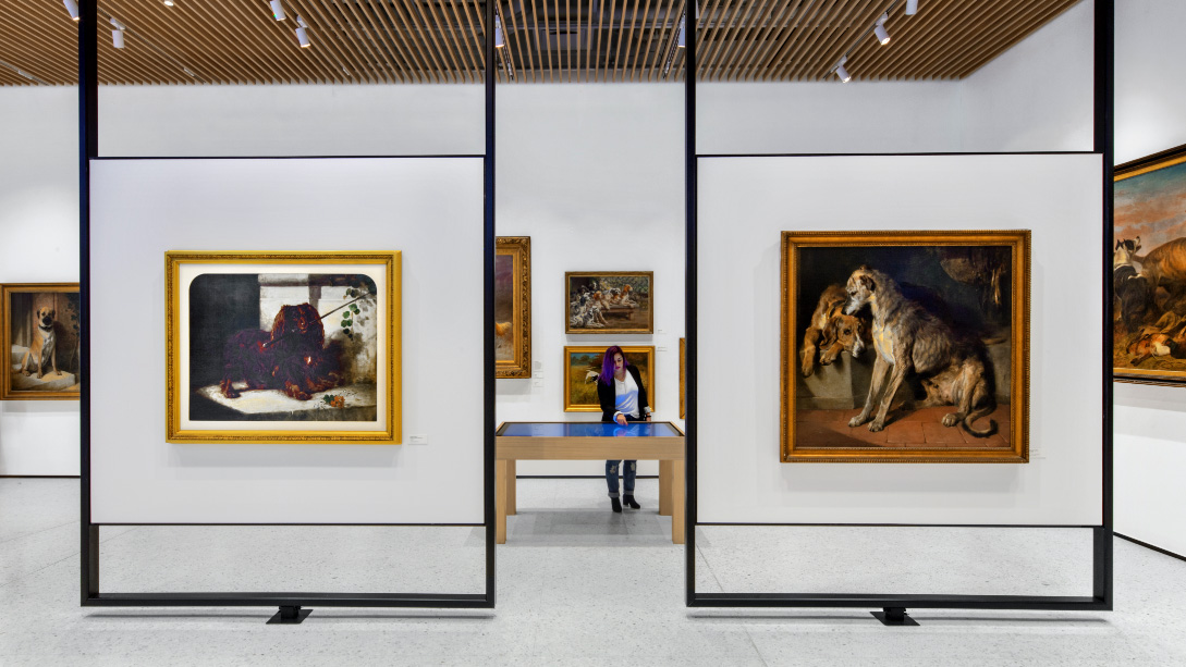A room with several paintings on the wall.