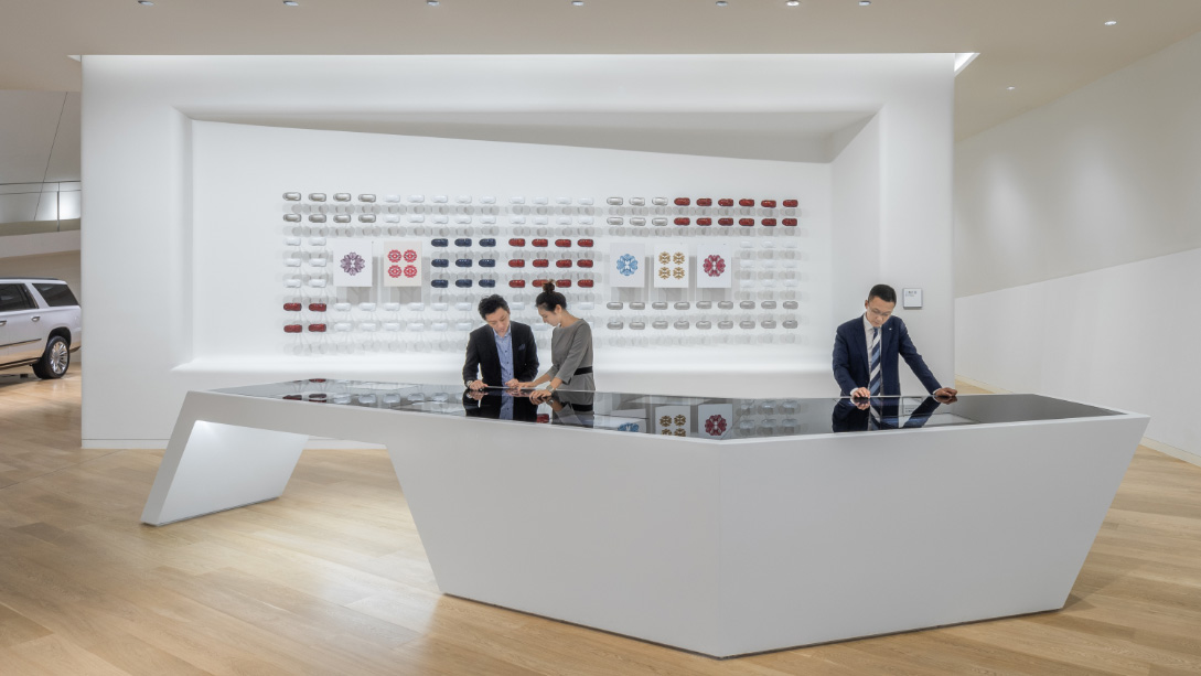 A group of people standing in front of a display of pictures.
