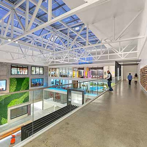 A large glass building with people walking around.