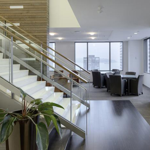 A staircase with a glass railing.