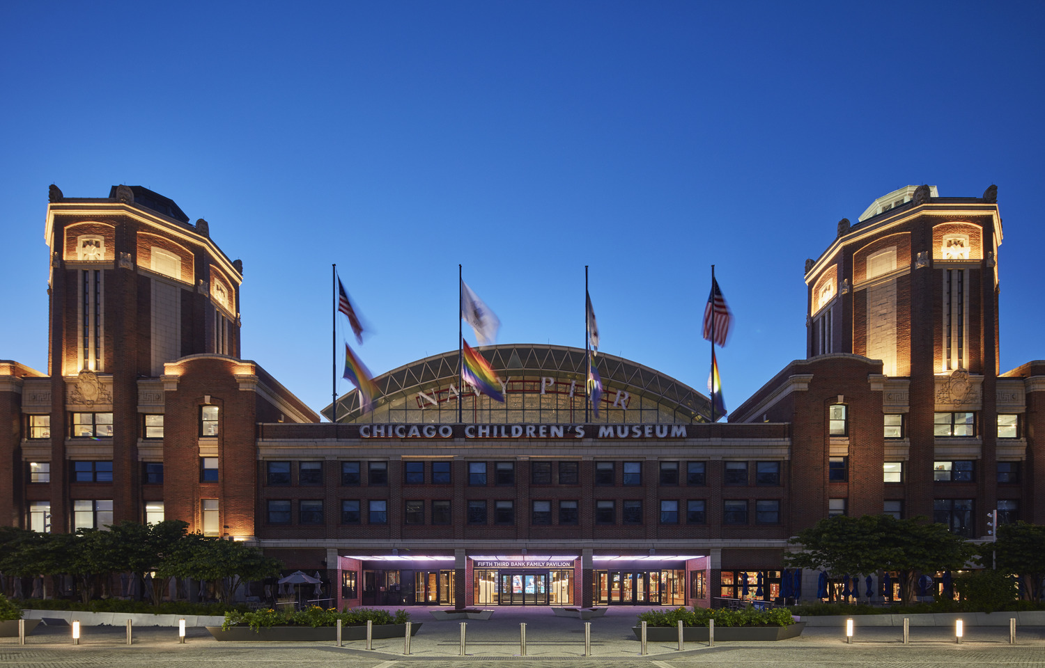 A large building with flags on the roof.