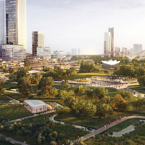 A park with trees and buildings in the background.