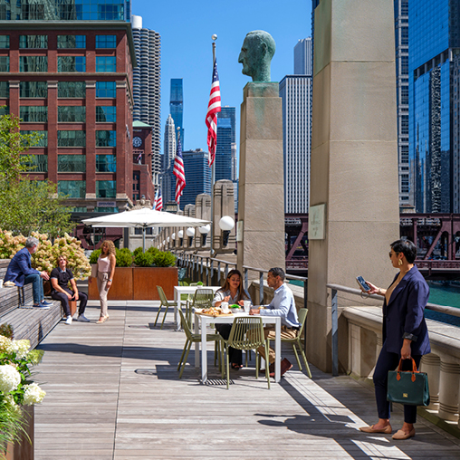 People sitting at tables outside.