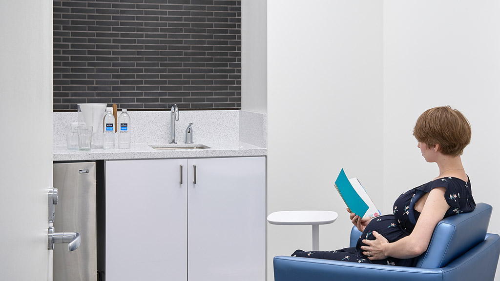 A person sitting in a chair reading a book.