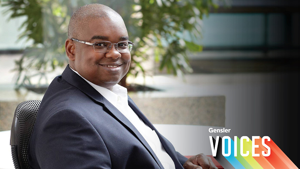 A man in a suit smiling.