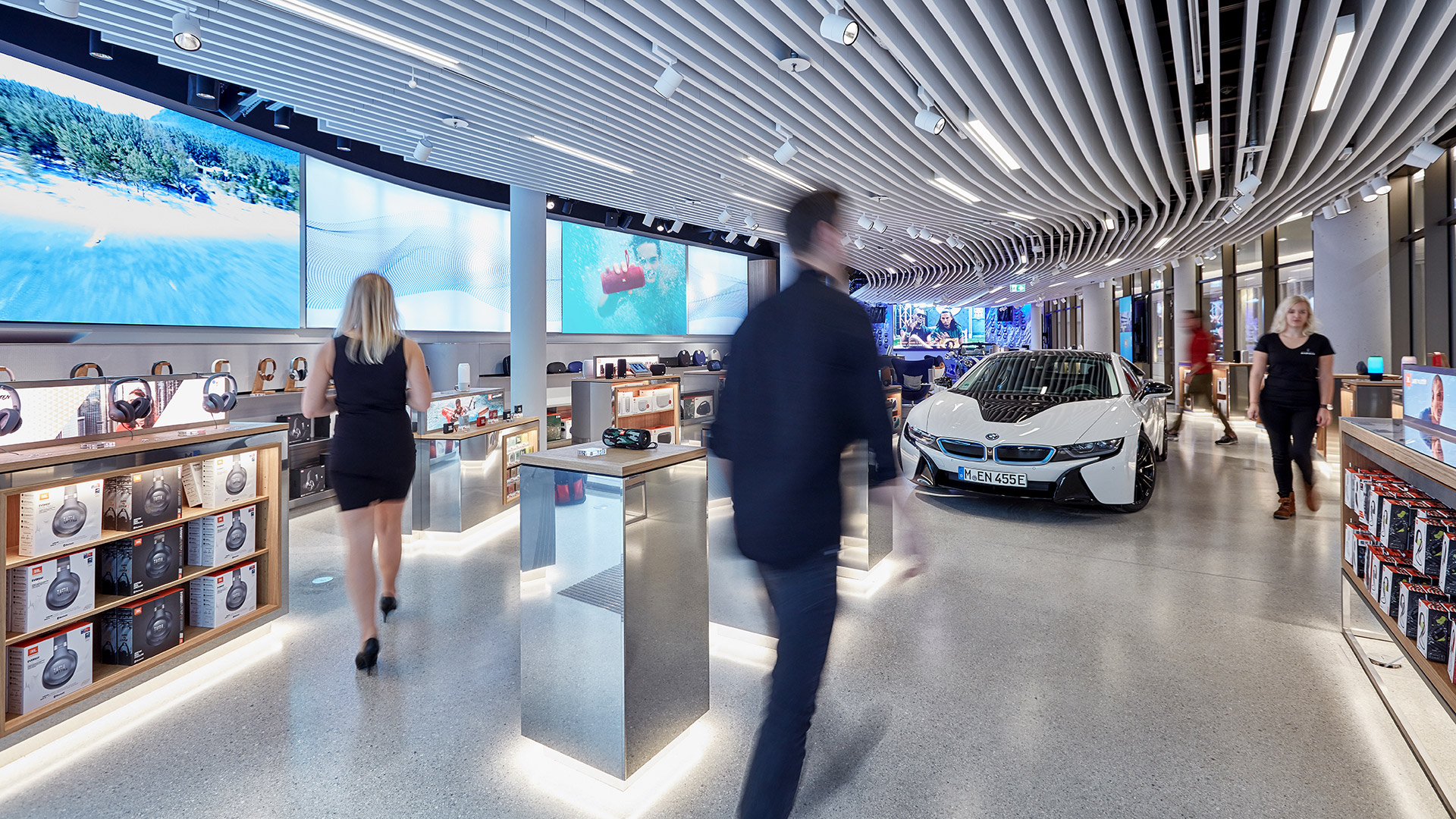 A man and woman walking in a store.