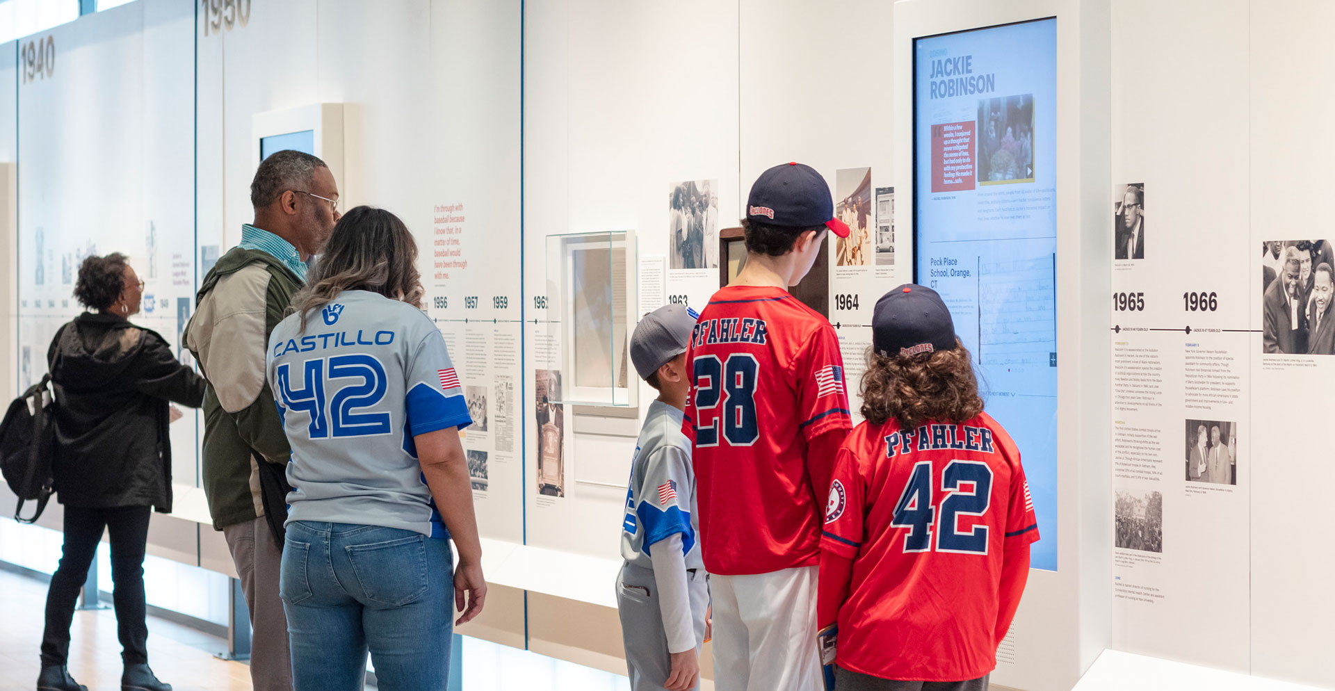 A group of people looking at a poster.