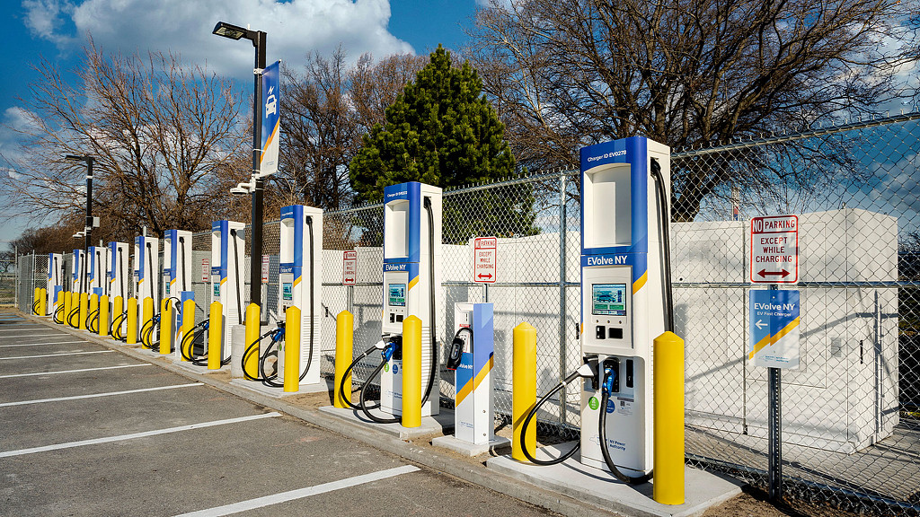 A row of yellow and blue gas pumps.