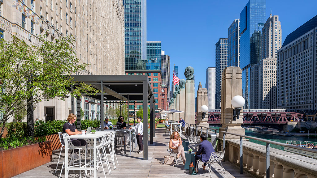 People sitting at tables in a city.