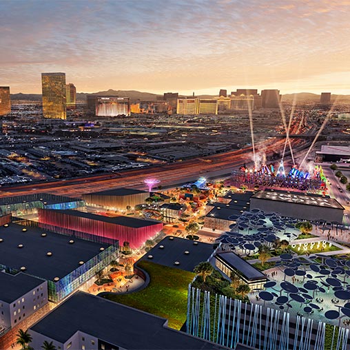 A city with a ferris wheel and a large crowd of people.