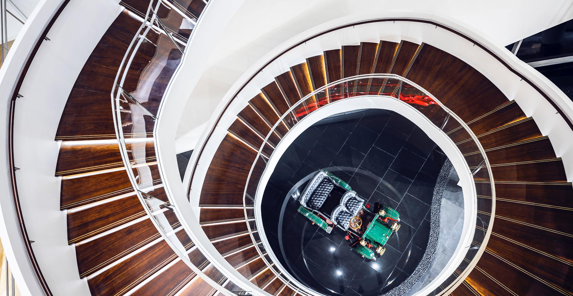 A spiral staircase with a few people.