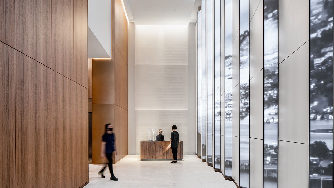 A man and a woman in a room with glass walls.