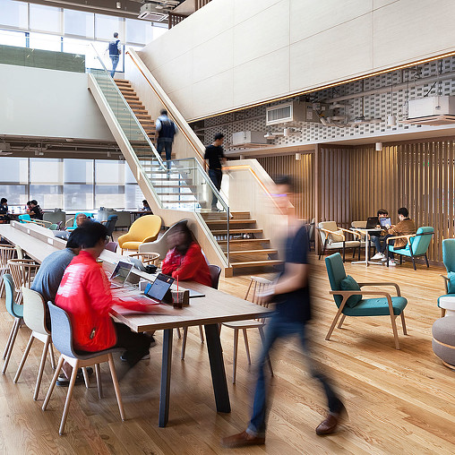 People sitting at tables in a building.