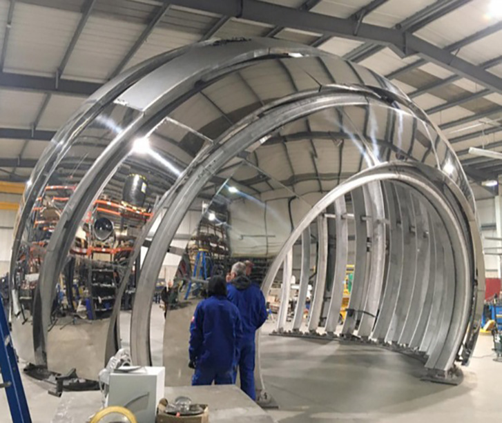 People looking at a large machine.
