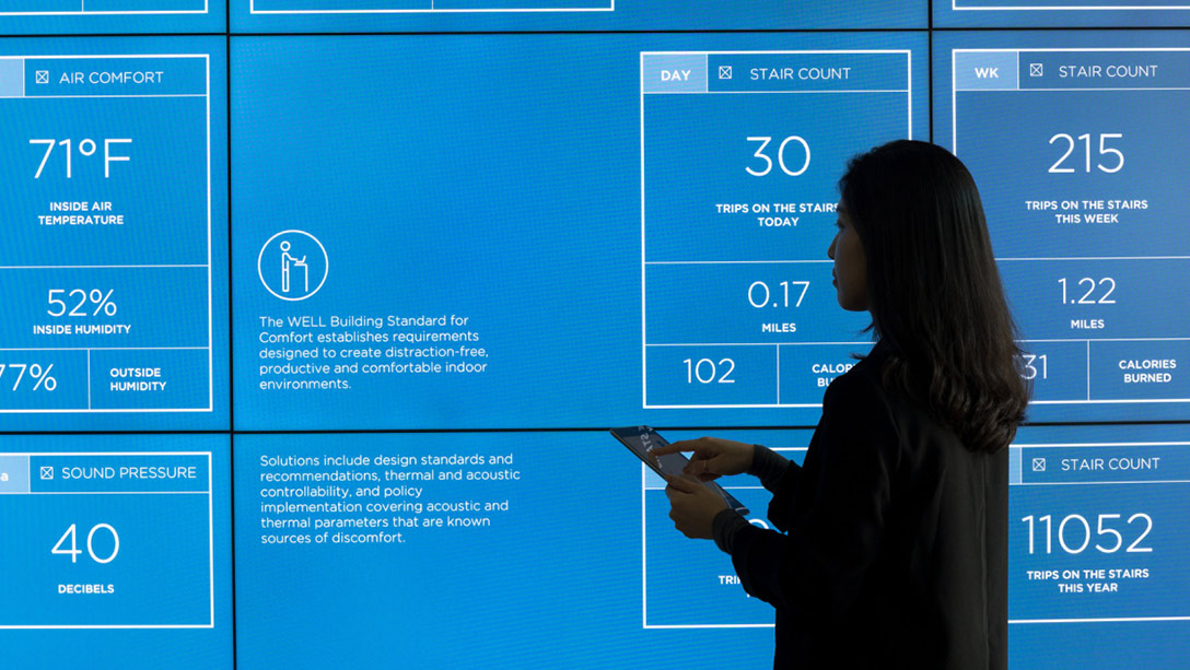 A person standing in front of a blue screen.