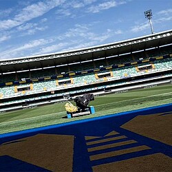 A person sitting on a bench in a stadium.
