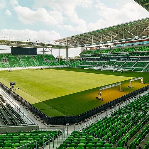 A sports stadium with green seats.