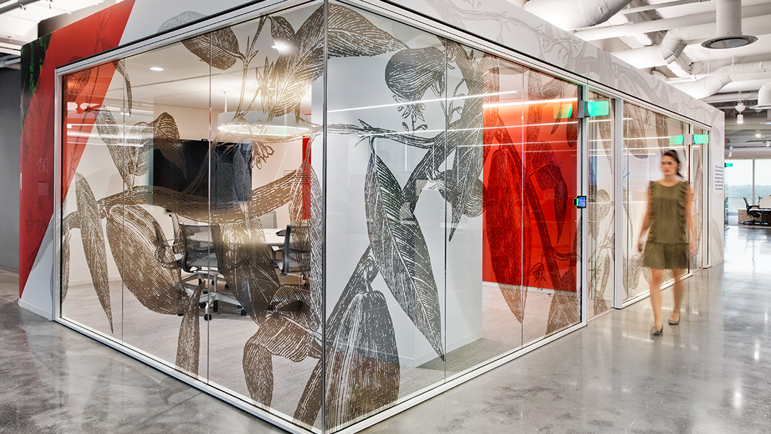 A person standing next to a glass display case.