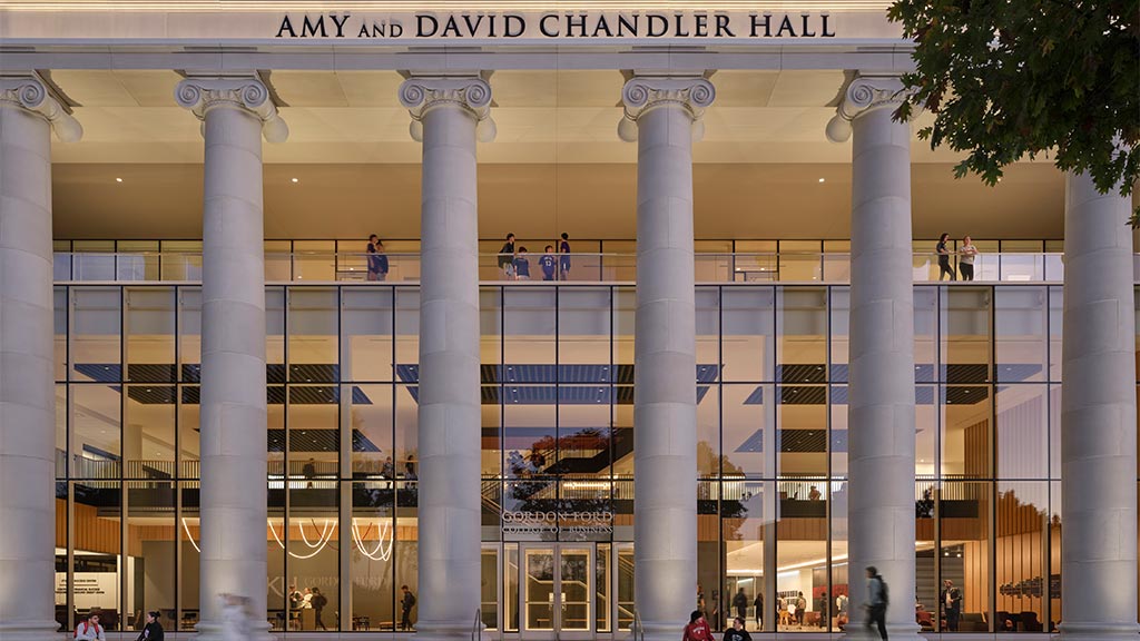 A building with pillars and people.