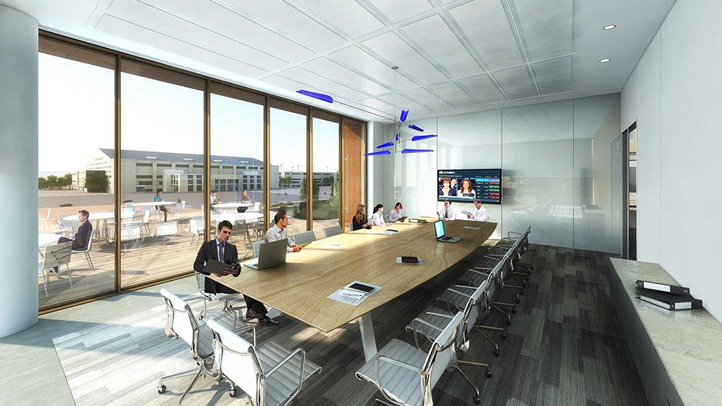 A group of people sitting at a table in a large room.