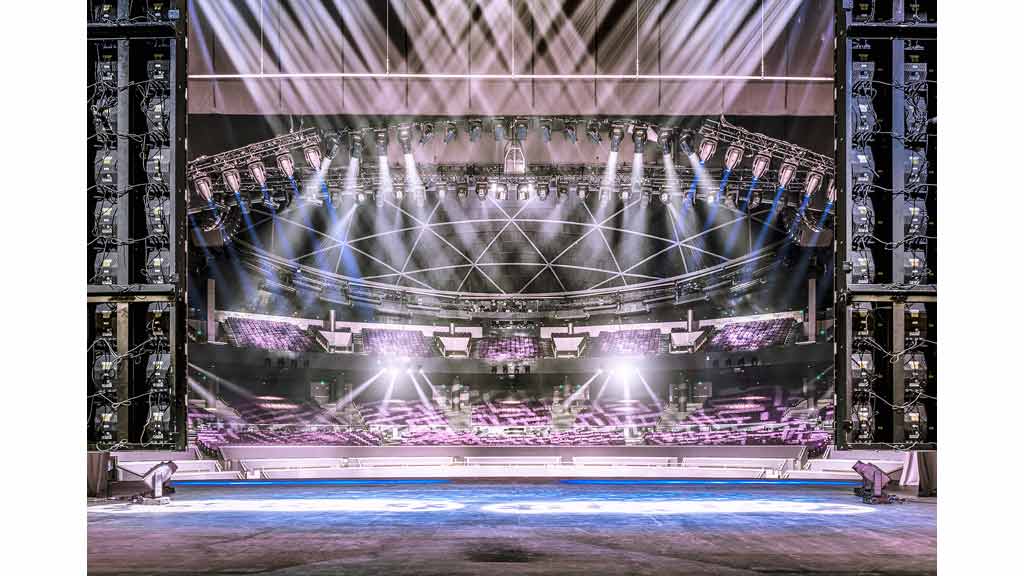 A large room with a stage and lights.