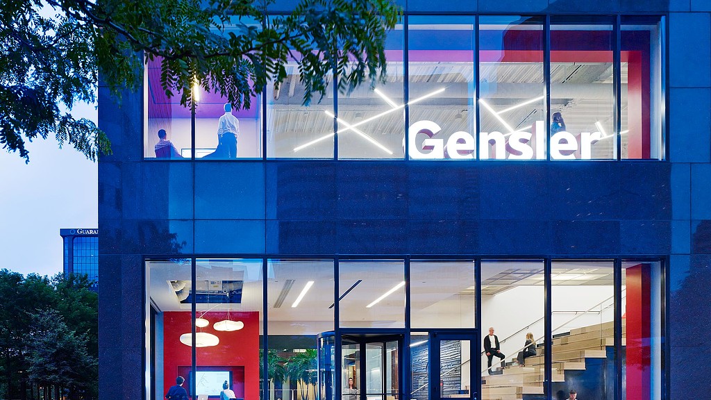 A building with windows and people walking around.