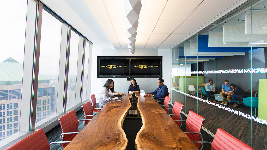 A group of people sitting around a table in a conference room.