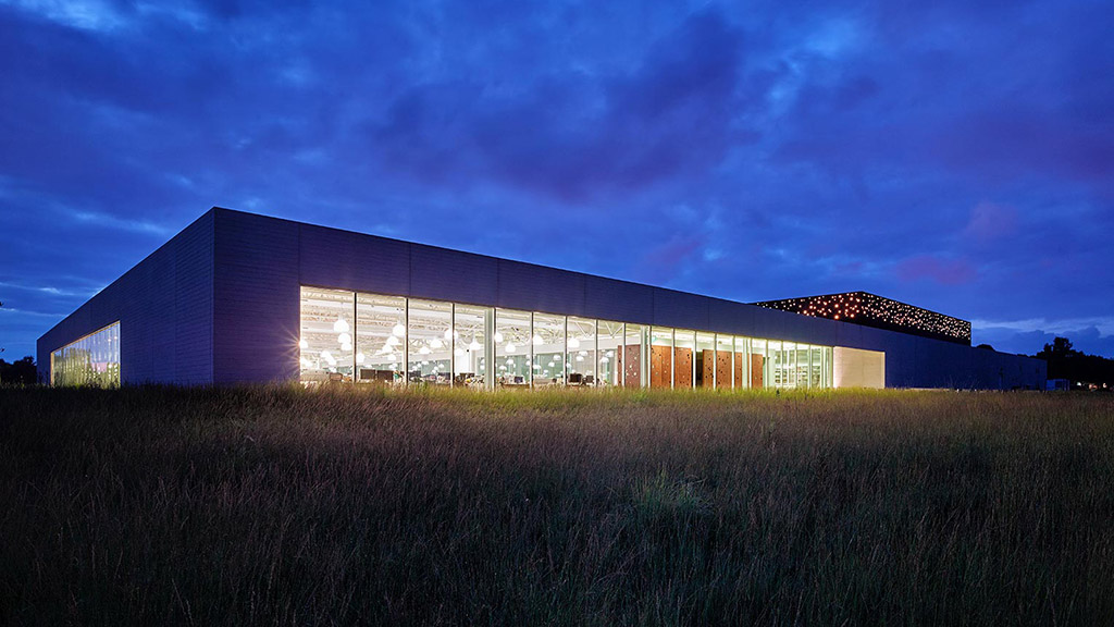 A building with lights on at night.