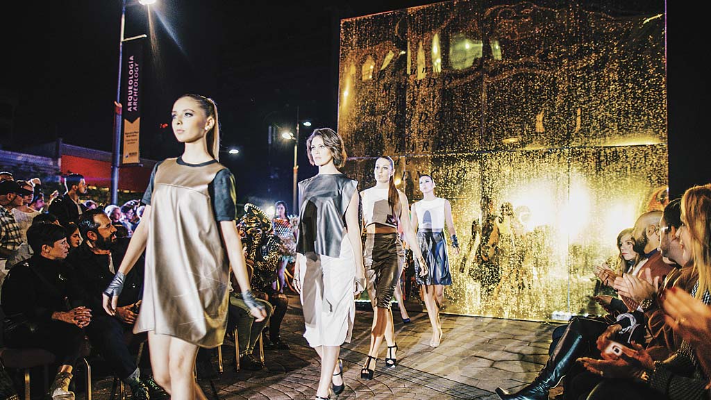A group of women walking down a runway.