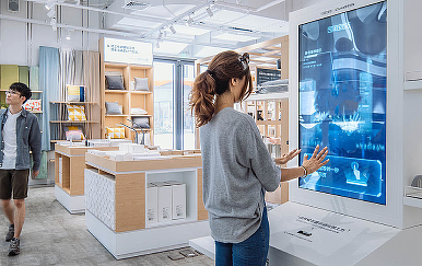 A person pointing at a screen.